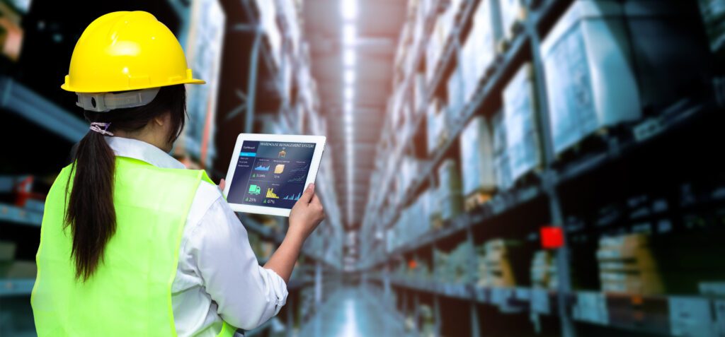 Person holding a tablet with warehouse data on it