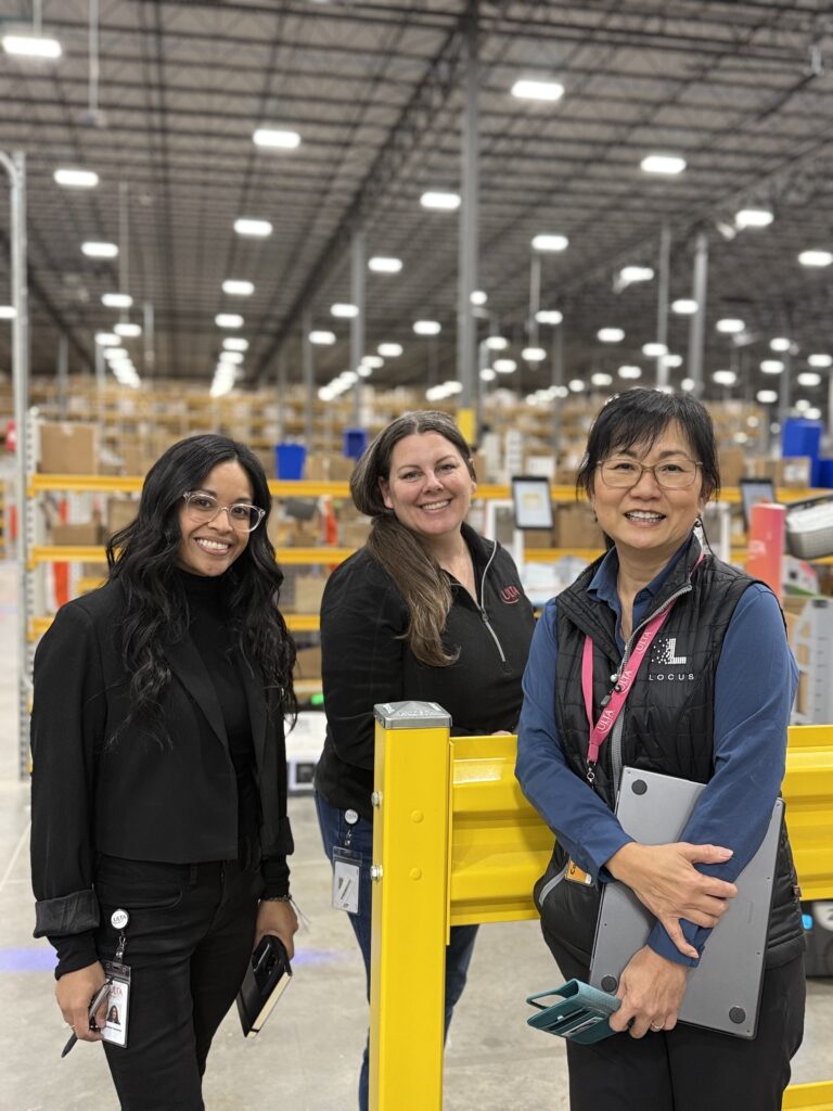 Three women in a warehouse