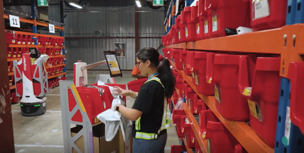 Woman working in a Staples Canada warehouse with Locus Origin