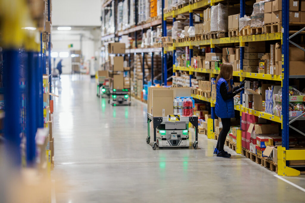 Picker working in warehouse with Vector and cart