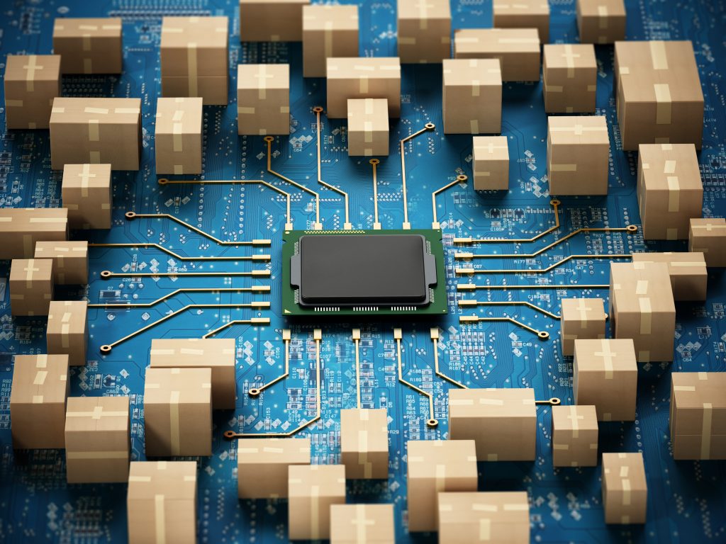 Cardboard boxes arranged around a computer chip on a blue circuit board